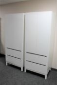 A pair of contemporary white double door wardrobes fitted with drawers