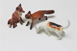 Two Beswick foxes and a Beswick beagle