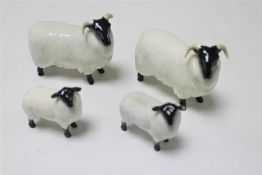 A pair of Beswick horned sheep and two Beswick lambs