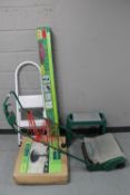 An electric lawn mower together with a set of folding garden steps,