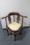 A reproduction mahogany corner armchair