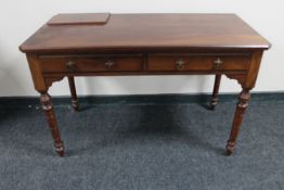 A Victorian mahogany two drawer side table on reeded legs