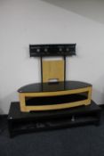 A contemporary glass topped TV stand together with a black ash two tier coffee table