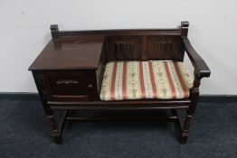 An oak linen fold telephone table with cushion