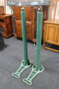 A pair of vintage cast iron tennis net posts on stands