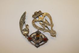An antique silver brooch together with a silver Scottish brooch and one further silver brooch.