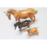 Three Beswick figures : Palomino horse and foal,