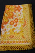 A 1970's orange and yellow woollen fringed rug