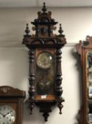 A 19th century stained pine and mahogany Vienna wall clock with brass dial