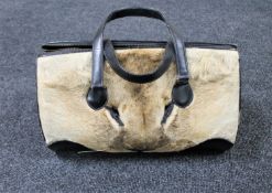 A mid twentieth century black leather and Lion skin hand bag