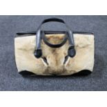 A mid twentieth century black leather and Lion skin hand bag