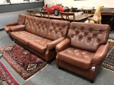 A mid century Danish brown leather lounge suite,