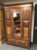 A late Victorian walnut mirror door wardrobe,