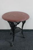 A circular cast iron Britannia bar table