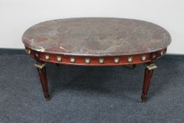 A continental oval marble topped coffee table with ormolu mounts