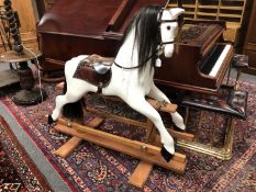 A painted wooden rocking horse,