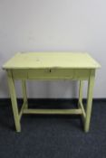 An antique painted pine kitchen table fitted with a drawer