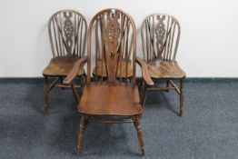 A set of four Windsor style wheel back dining chairs