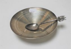 A circular silver shallow dish, width 12.