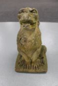 A weathered concrete garden figure of a Griffin,