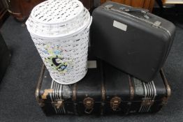 A wooden bound travelling trunk together with a wicker linen basket and a mid century luggage case