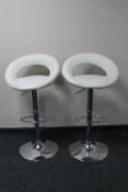 A pair of contemporary gas lift bar stools