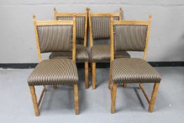 A set of four blond oak dining chairs upholstered in a checkered fabric
