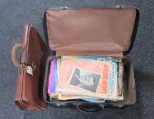 A vintage luggage case containing sheet music and a leather briefcase