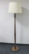 An early twentieth century oak standard lamp with shade (no plug)
