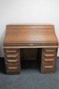 An Edwardian oak roll top desk