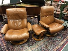 A pair of Ekornes Stressless tan leather adjustable armchairs and one stool
