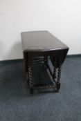 An antique carved oak barley twist gateleg table