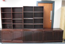 Two sets of open bookshelves and a double door cupboard