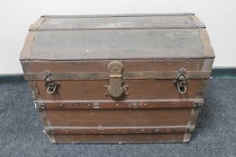 An antique wooden bound domed shipping trunk