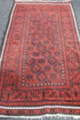An Afghan Bokhara rug on red ground