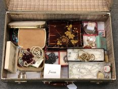 A suitcase containing a large quantity of costume jewellery, compacts, pill boxes,