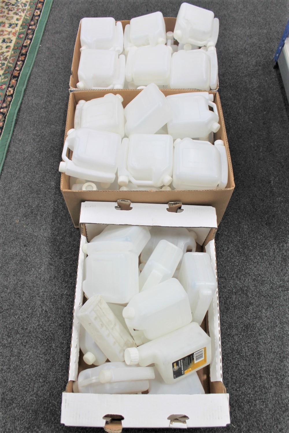 Three boxes and a bag of plastic fuel mixing bottles