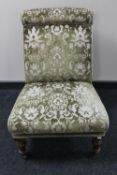 A Victorian bedroom chair upholstered in a green brocade fabric