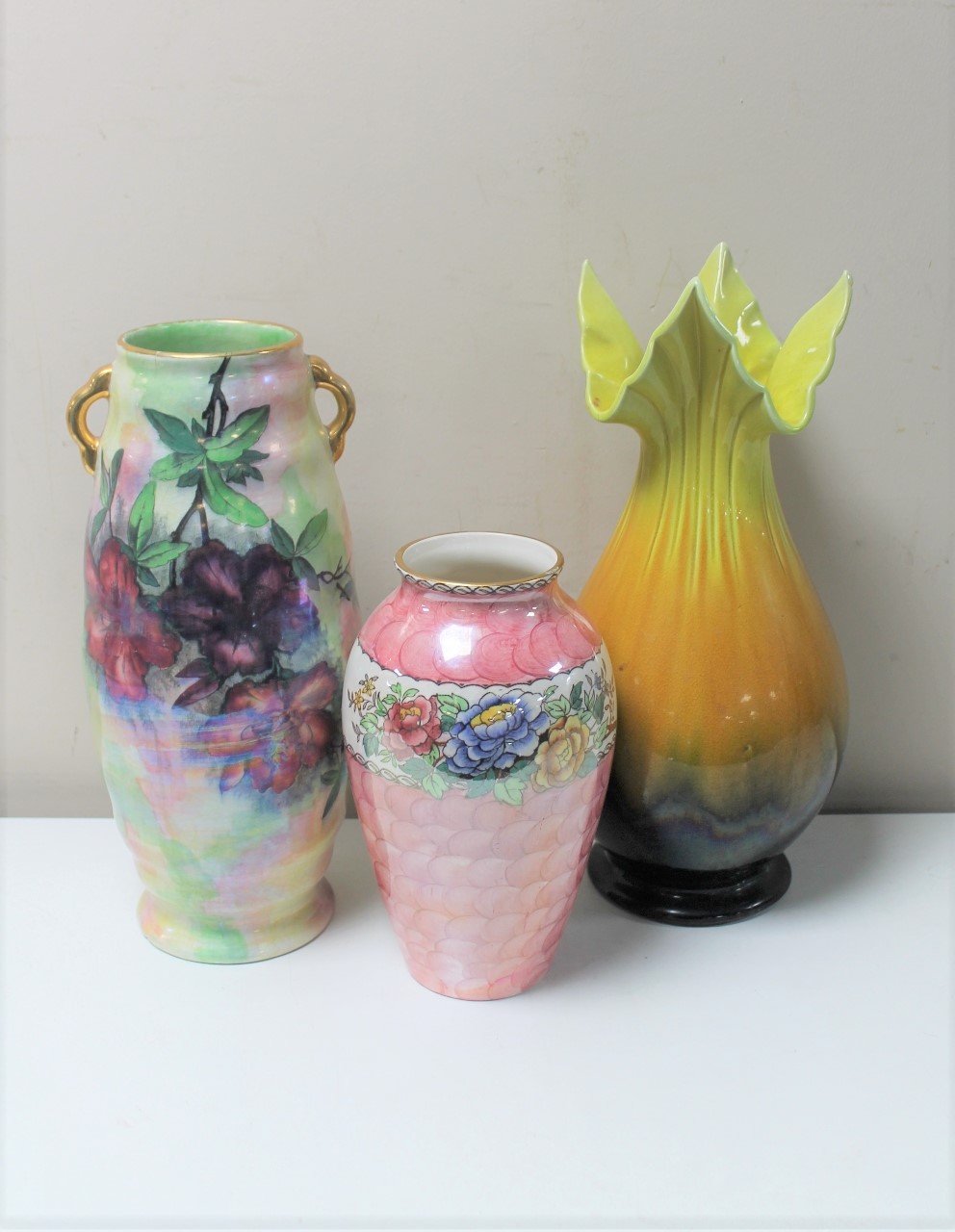 A Maling Peony rose vase together with a further Maling vase and antique Bretby pottery vase
