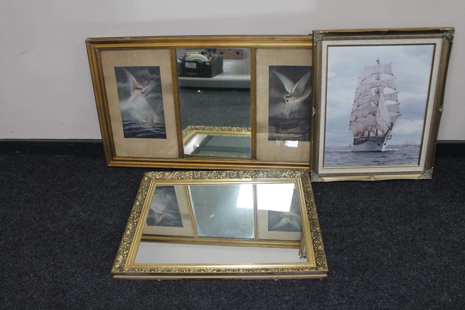 An Edwardian gilt framed mirror with two framed prints framed as one together with a gilt framed