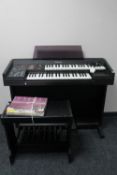 A Technics Sound VX 10L electric organ with stool and books