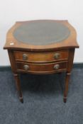 A mahogany Regency style two drawer table with green tooled leather panel on reeded legs