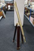 A brass telescope on brass and mahogany extending tripod