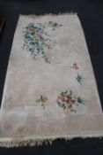 A fringed floral Chinese rug