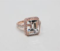A 14ct rose gold aquamarine and diamond cluster ring,