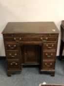 A George III inlaid oak kneehole desk of neat proportions,