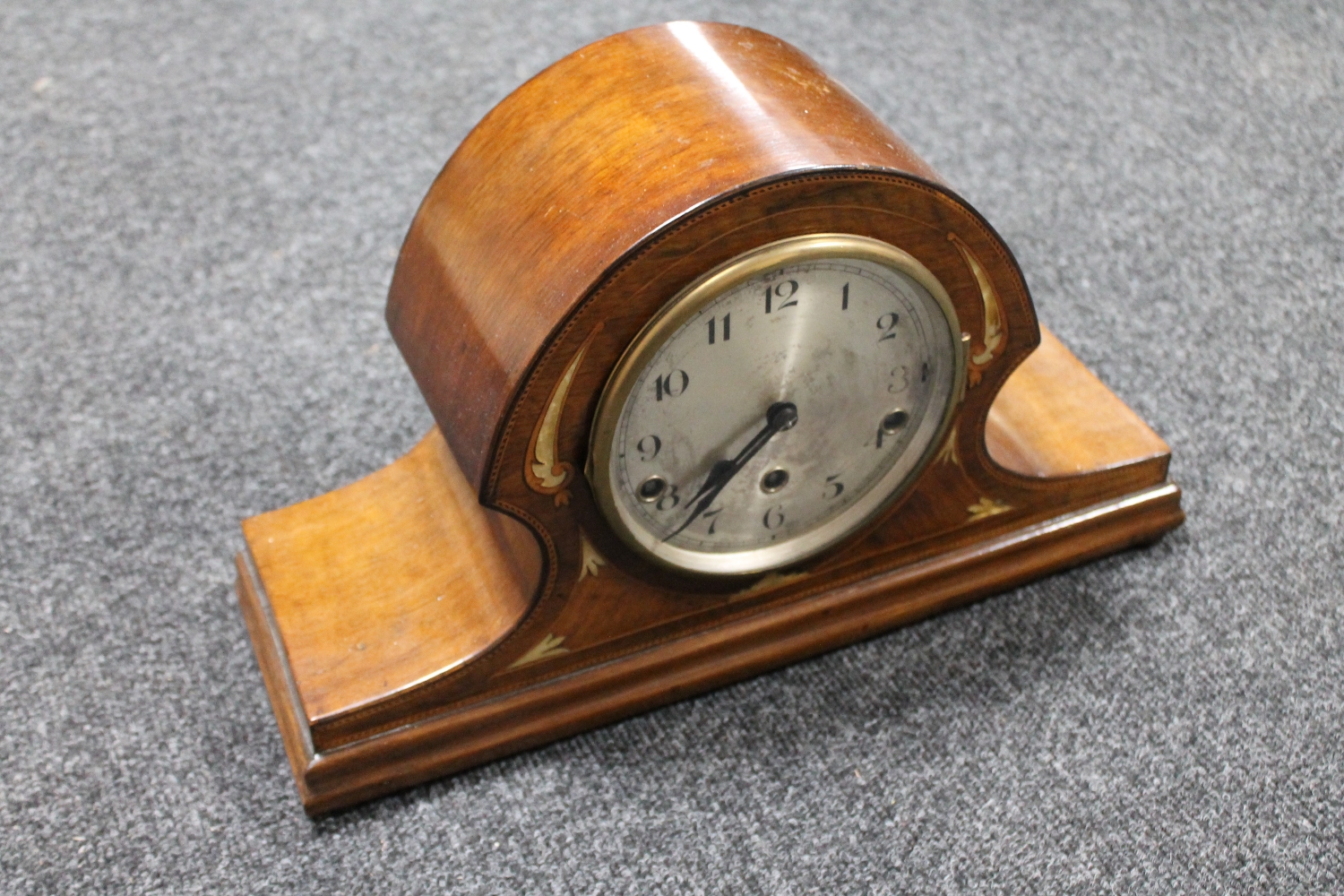 An inlaid mahogany mantel clock