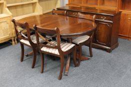 A six piece inlaid mahogany Regency style dining room suite comprising of triple door sideboard,