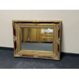 A Victorian style red and gilt framed mirror