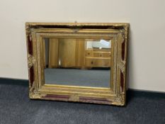 A Victorian style red and gilt framed mirror